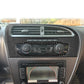 Black carbon-fiber center console trim panel around air vents and control knobs