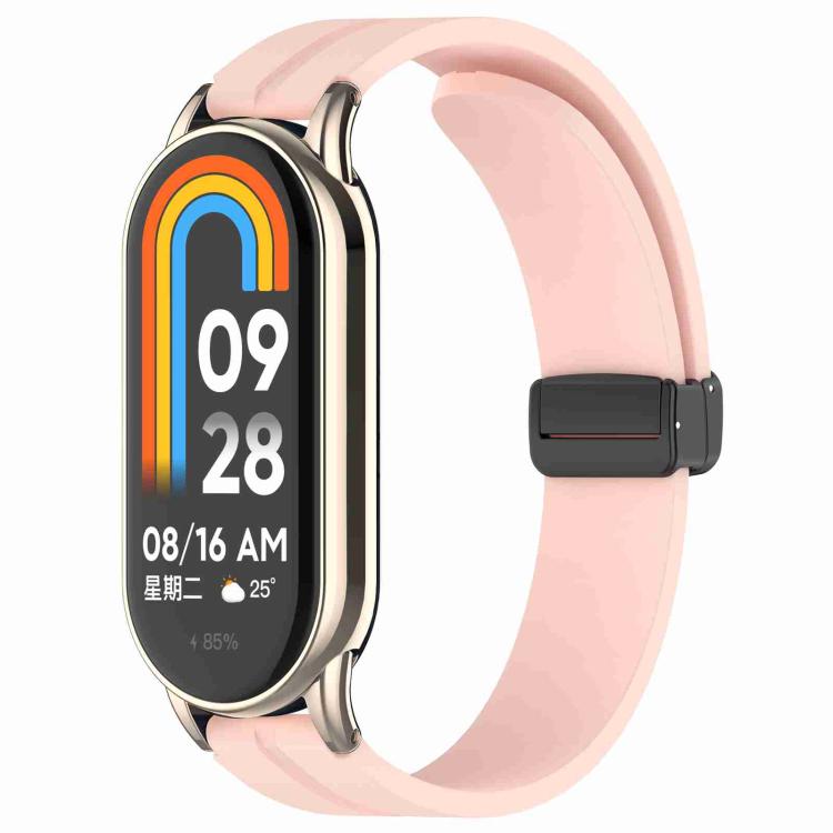 Pink silicone watch band with folding buckle, shown attached to a smartwatch