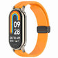 xDfind silicone watch band in bright orange with folding buckle, shown attached to a smartwatch