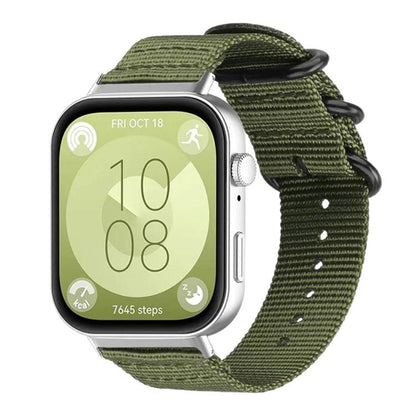 Army green nylon canvas watch band with black ring buckle, shown on a silver smartwatch