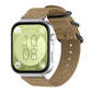 Khaki nylon canvas watch band with black ring buckle, shown on a silver smartwatch