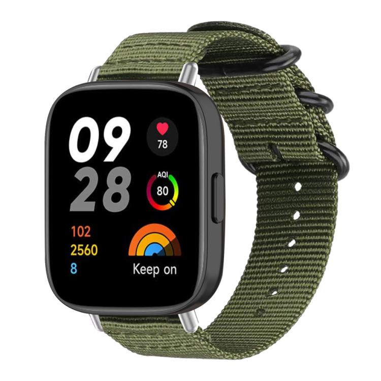 Army green nylon canvas smartwatch band with black ring buckle, shown attached to a watch