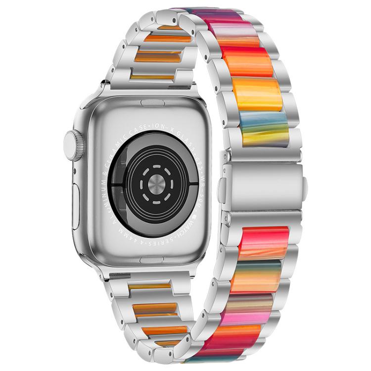 Silver metal and resin Apple Watch band with rainbow-colored links, shown on a watch