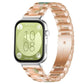 Rose gold metal watch band with green and peach resin links and three-bead accents