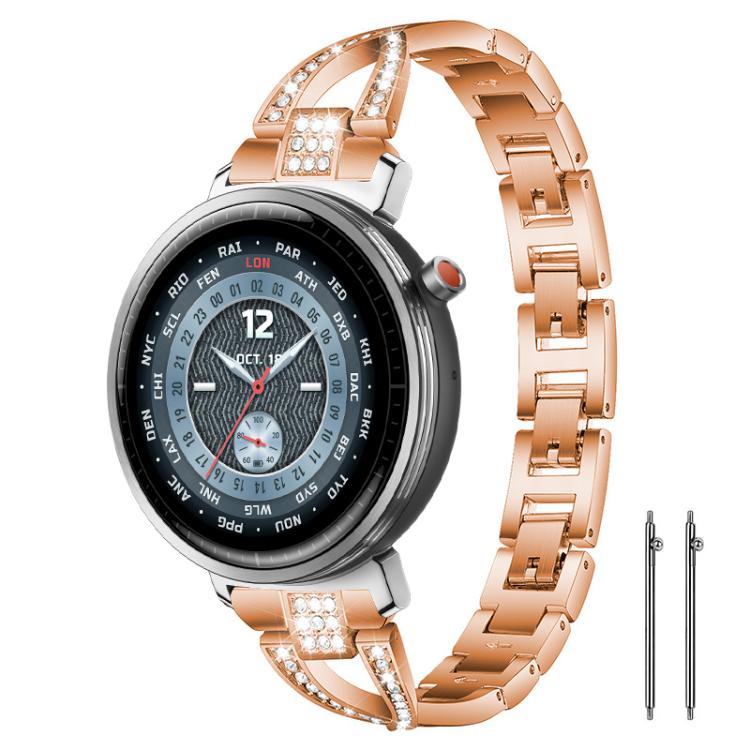 Rose gold X-shaped metal watch band with crystal accents, shown on a round watch