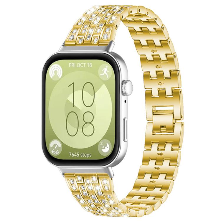 Gold metal smartwatch band with five rows of clear stones, shown on a smartwatch.