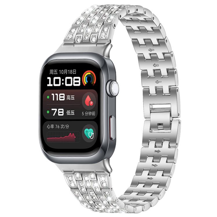 Silver metal smartwatch band with five rows of clear stones, shown attached to a watch.