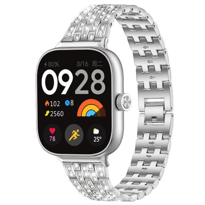 Silver metal smartwatch band with rows of clear stones and a linked bracelet.