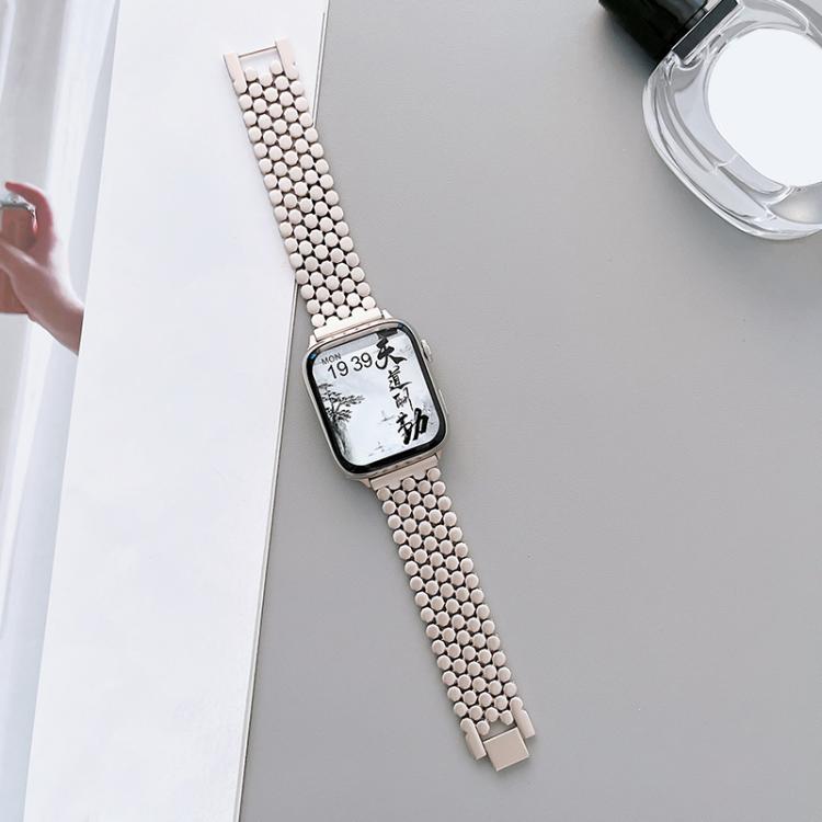 Rose gold fish-scale metal band fitted to an Apple Watch