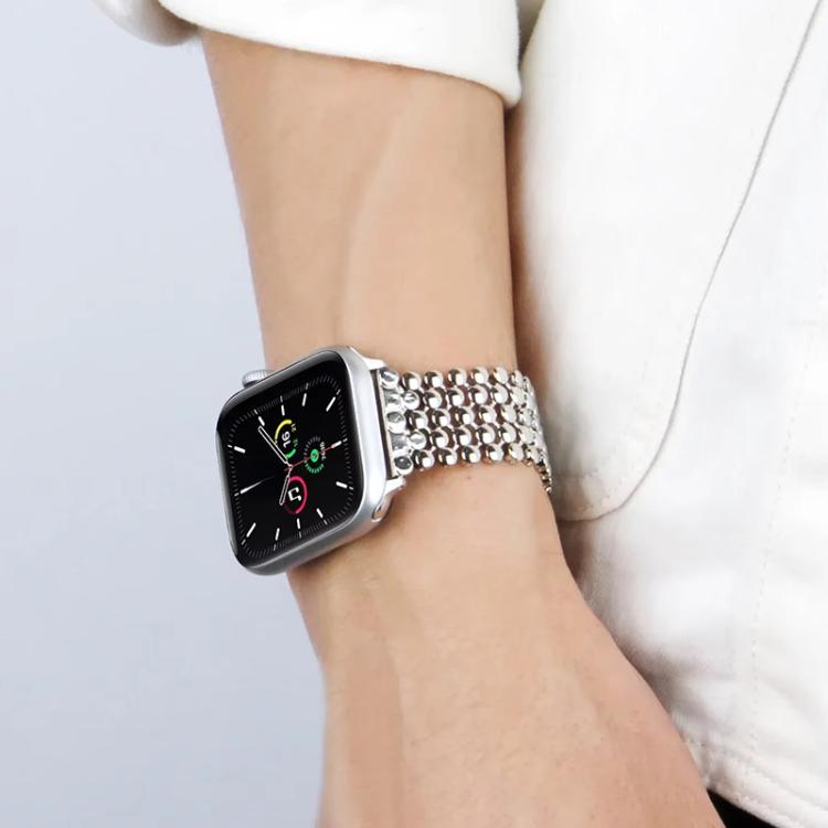 Silver fish-scale metal Apple Watch band worn on the wrist