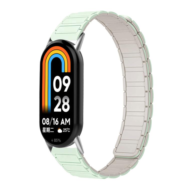 Two-tone silicone watch band in mint and pale starlight, shown on a smart band.