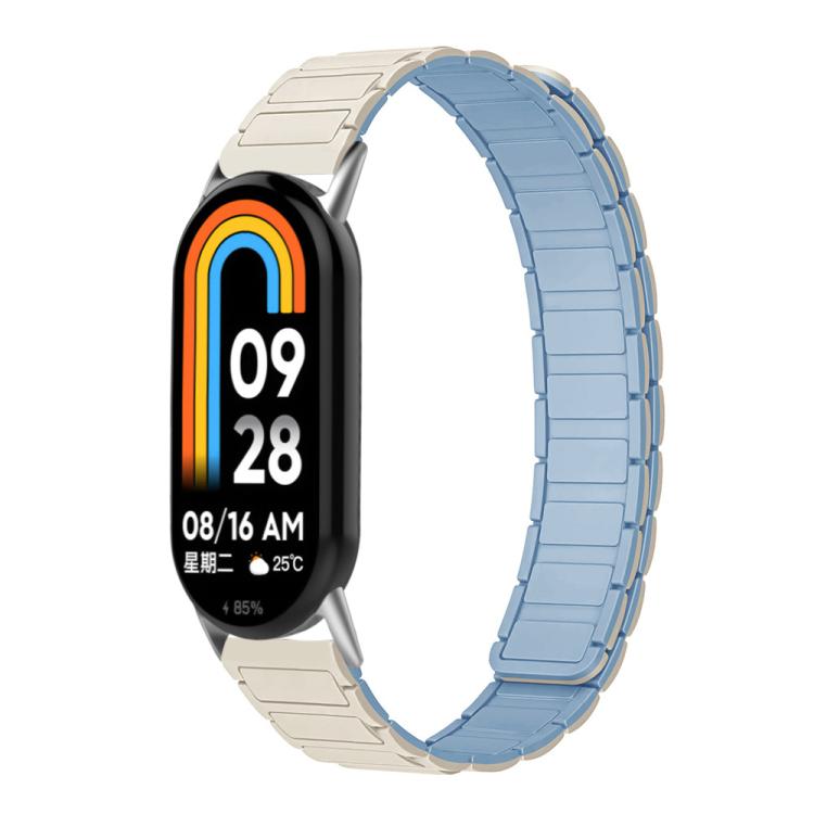 Two-tone silicone watch band in light blue and pale starlight, shown on a smart band.