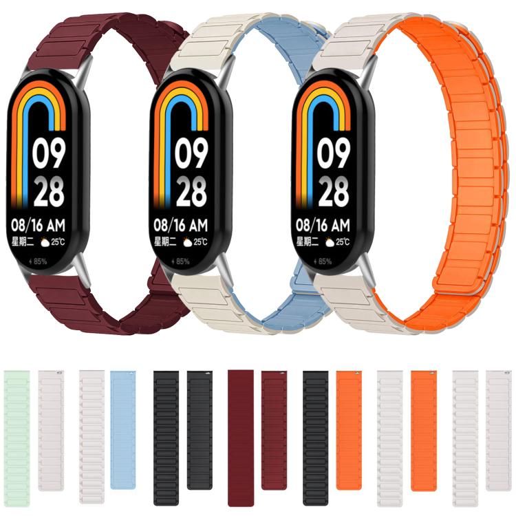 Four smart bands display silicone straps in wine red, blue and starlight, and orange.