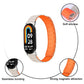 Starlight and orange silicone watch band with close-ups of its magnetic connection and soft strap.