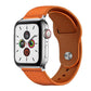 Orange leather watch band with stitched edges, brown lining, and metal rivet buckle