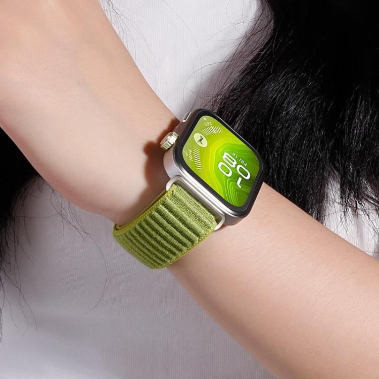 Green woven nylon watch band worn on a wrist with a smartwatch.
