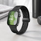 Black perforated silicone watch band with a black magnetic buckle, worn on a smartwatch