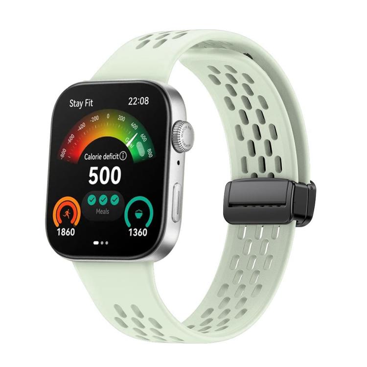 Pale green perforated silicone watch band with a black magnetic buckle, attached to a smartwatch