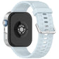 Light blue silicone watch band with silver buckle, shown attached to a smartwatch