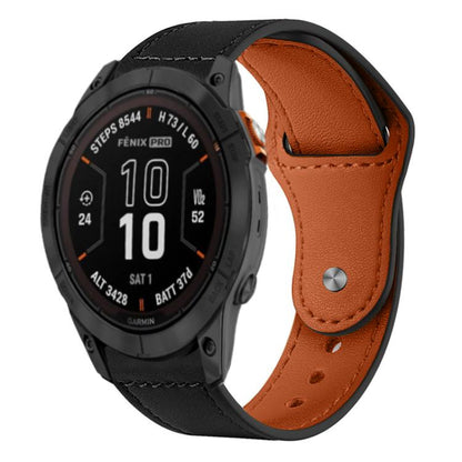 Leather watch band with black exterior, brown lining, stitching, and metal rivet buckle