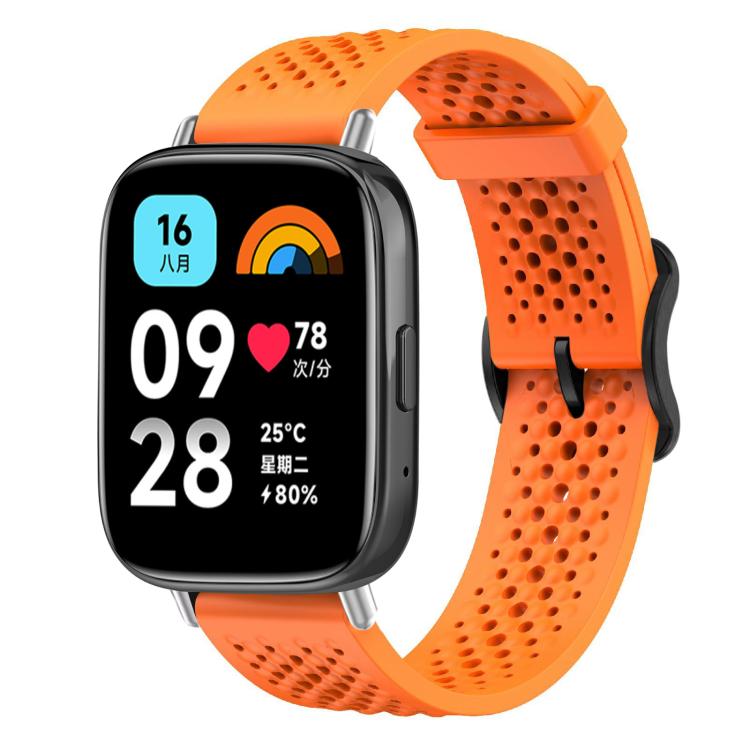 Orange perforated silicone watch band on a black smartwatch
