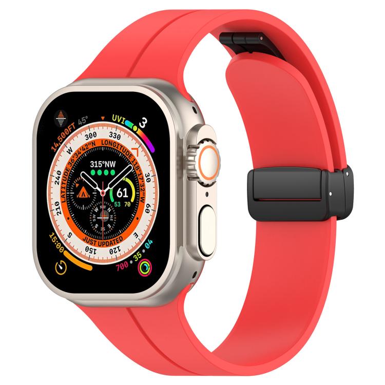 Red silicone watch band with black folding buckle, shown on an Apple Watch