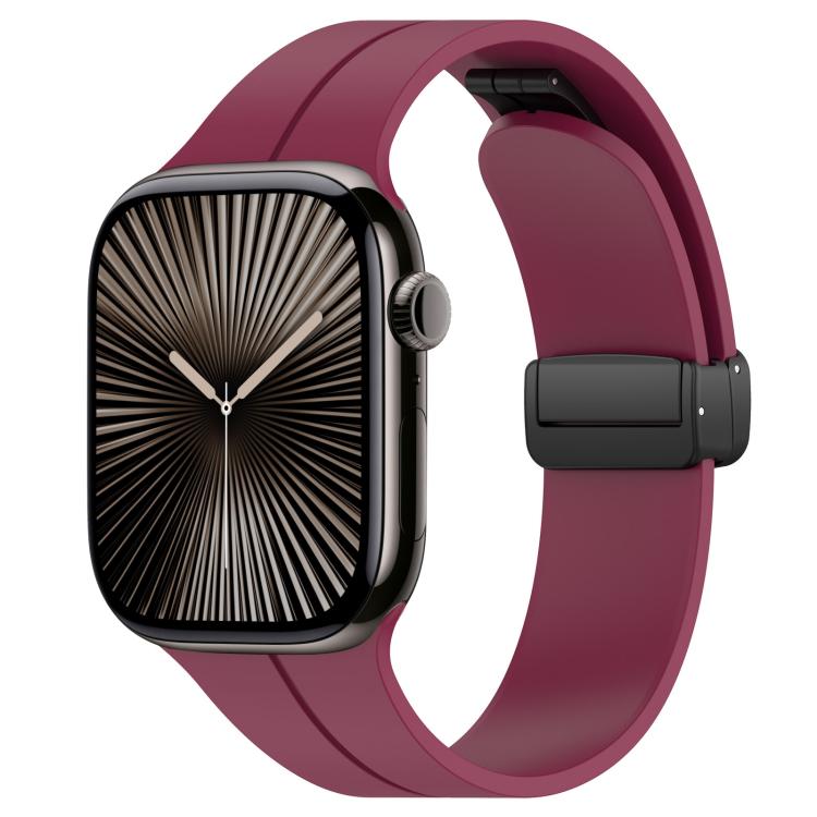 Wine red silicone watch band with black folding buckle, shown on an Apple Watch