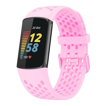 Light pink perforated silicone watch band with a tracker and matching buckle