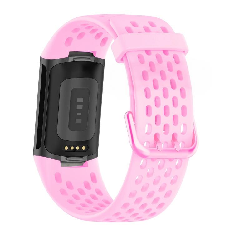 Pink perforated silicone watch band for Fitbit Charge 6/5, shown with tracker underside