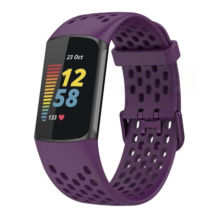 Purple perforated silicone watch band fitted to a Fitbit Charge 6/5 tracker