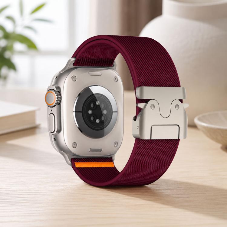 Wine red xDfind nylon watch band with parachute buckle, shown on the back of an Apple Watch