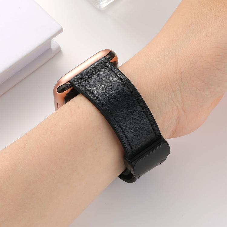 Black silicone watch band worn on a wrist with a rose-gold watch
