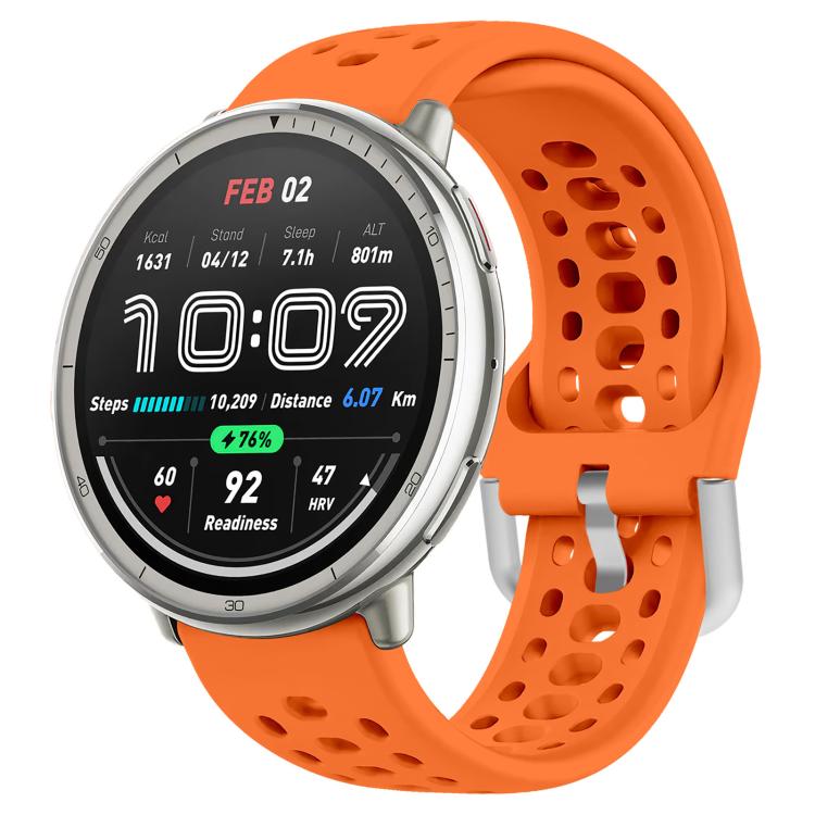 Orange perforated silicone sport watch band fitted to a silver smartwatch
