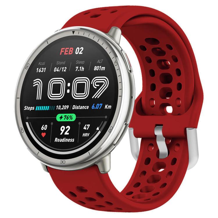 Red perforated silicone sport watch band fitted to a silver smartwatch