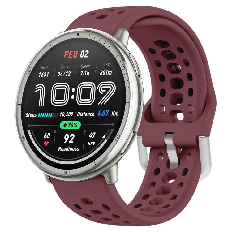 Wine red perforated silicone sport watch band fitted to a silver smartwatch