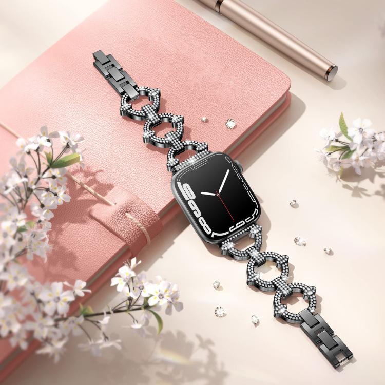 Black Apple Watch band with crystal-studded O-shaped links, laid flat