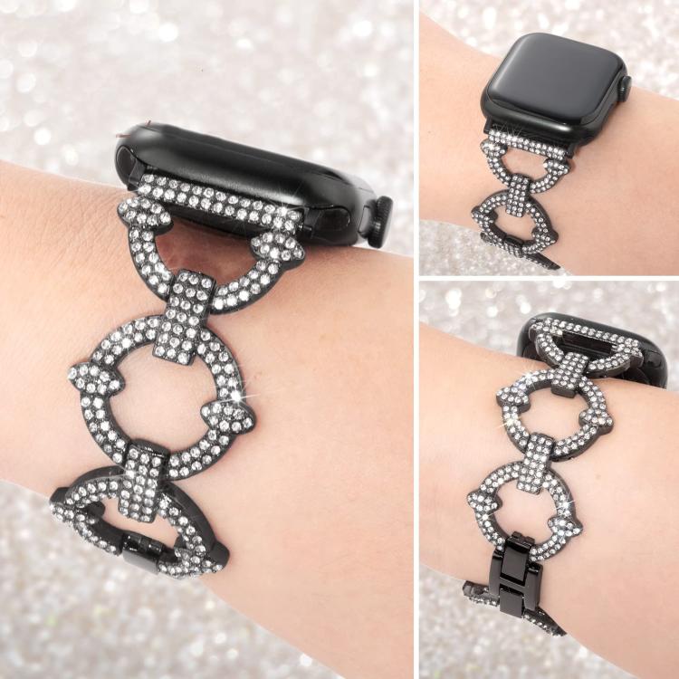 Black metal Apple Watch band with crystal-studded O-shaped links, shown on wrist