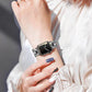 Silver metal Apple Watch band with O-shaped links and a decorative crystal row, worn on wrist