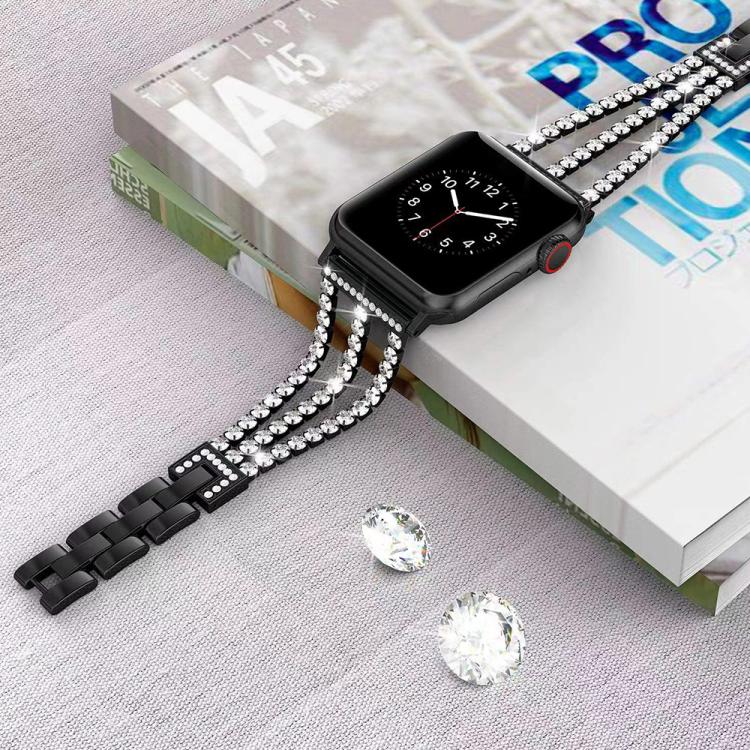 Black three-row rhinestone metal Apple Watch band attached to a watch