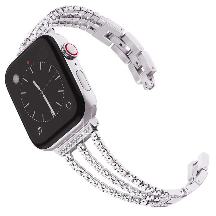 Silver three-row metal Apple Watch band with rhinestones, shown attached to a watch