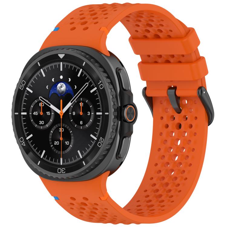 Orange perforated silicone watch band with black buckle on a smartwatch