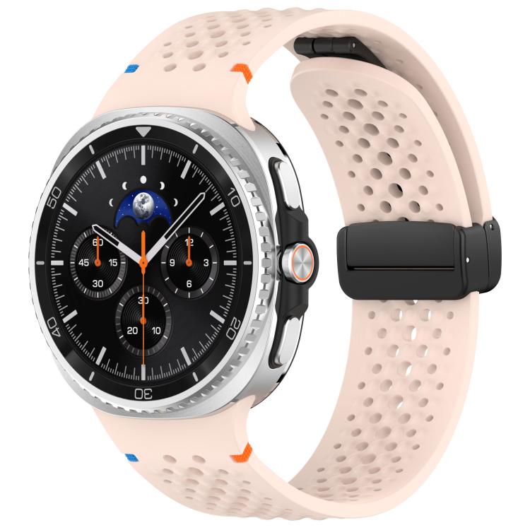 Pale pink perforated silicone watch band with black magnetic buckle, shown on a watch