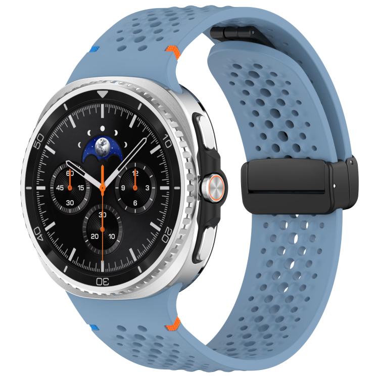 Blue perforated silicone watch band with black magnetic buckle, shown on a watch