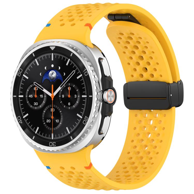 Yellow perforated silicone watch band with black magnetic buckle, shown on a Galaxy watch.