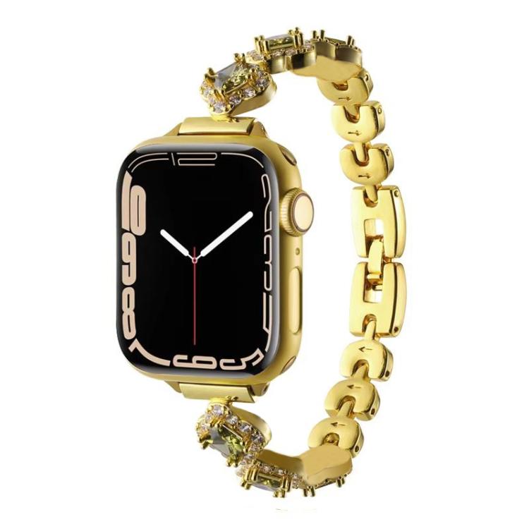 Gold metal Apple Watch band with crystal clover links, shown attached to a watch