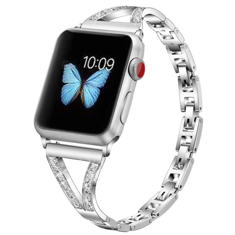 Silver stainless steel watch band with crystal-set herringbone connectors, shown on a watch.
