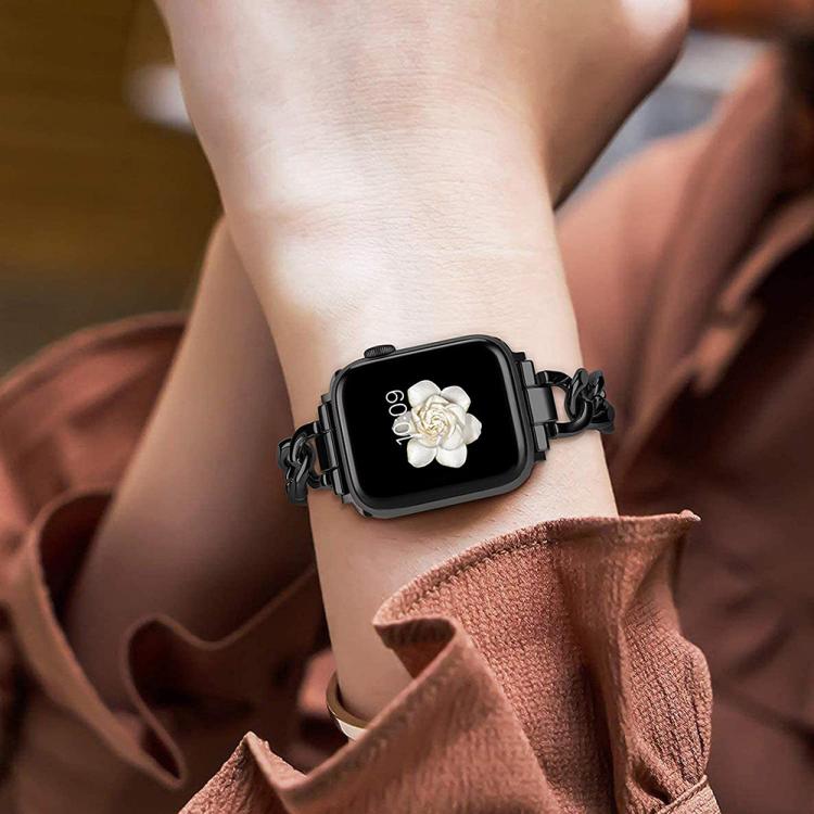 Black metal chain-link Apple Watch band worn on a wrist