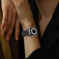 Black braided stainless steel Apple Watch band worn on wrist