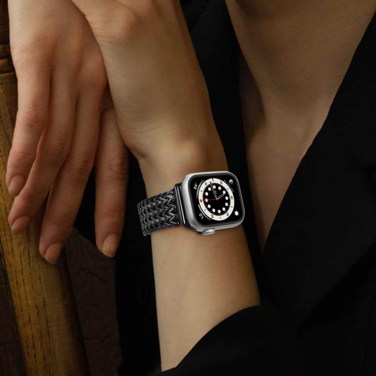 Black braided stainless steel Apple Watch band worn on wrist