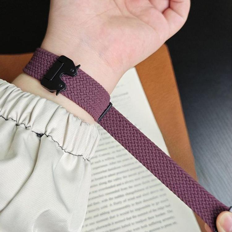 Plum braided watch band with a black snap buckle worn on a wrist